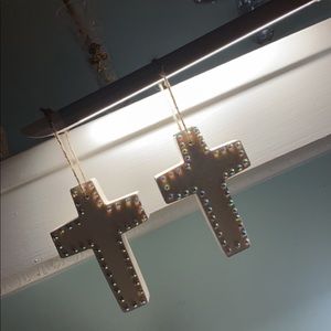 Wooden cross with colorful studs.